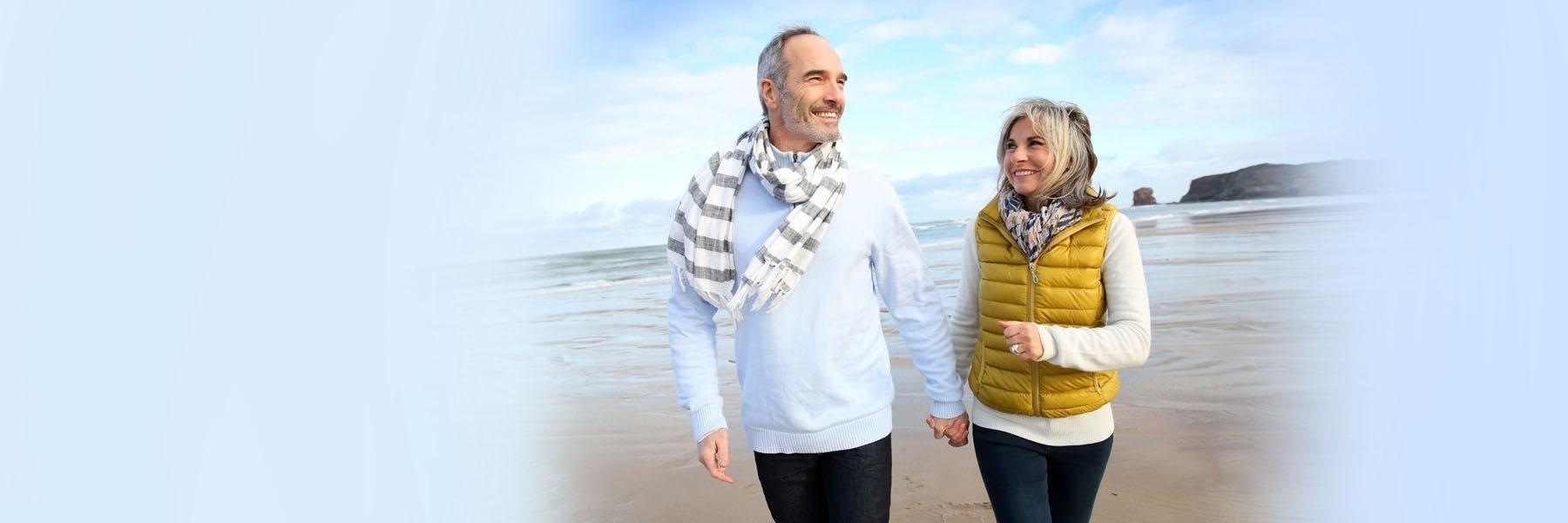 older couple walking on beach l preventative dentist bangor me