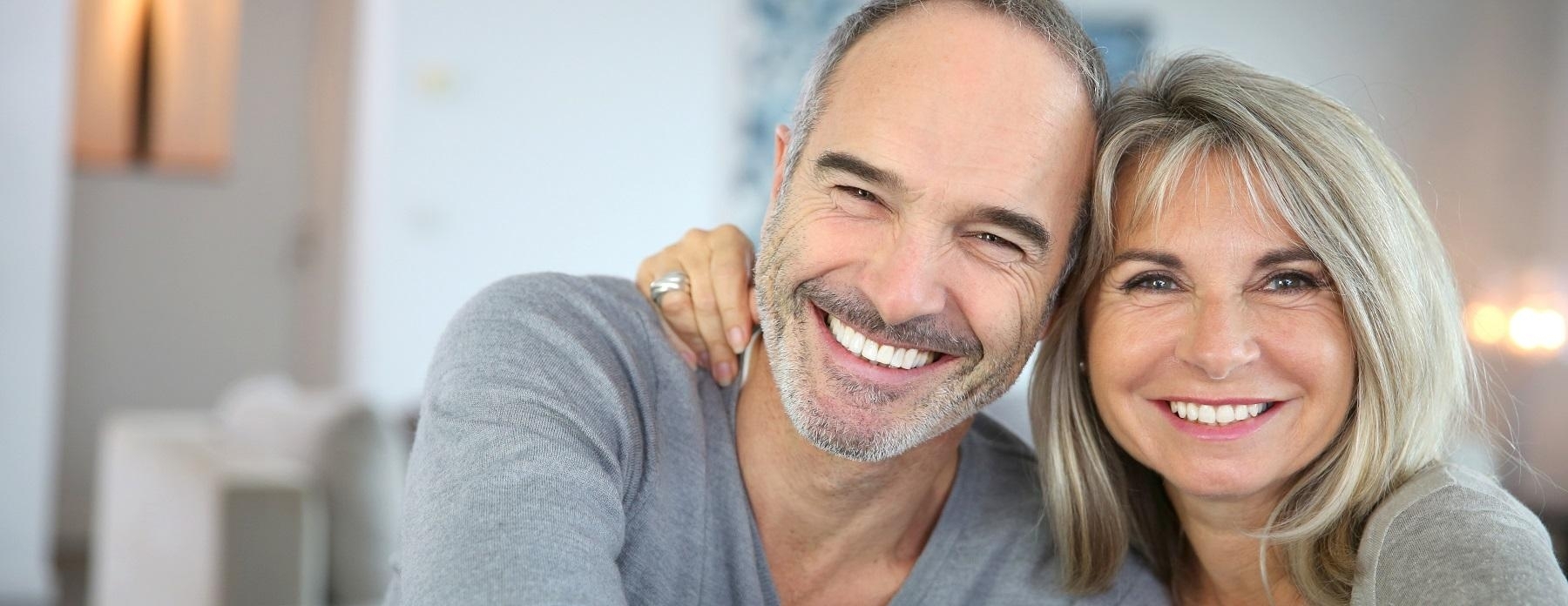 older couple smiling and holding one another | dentist 04401